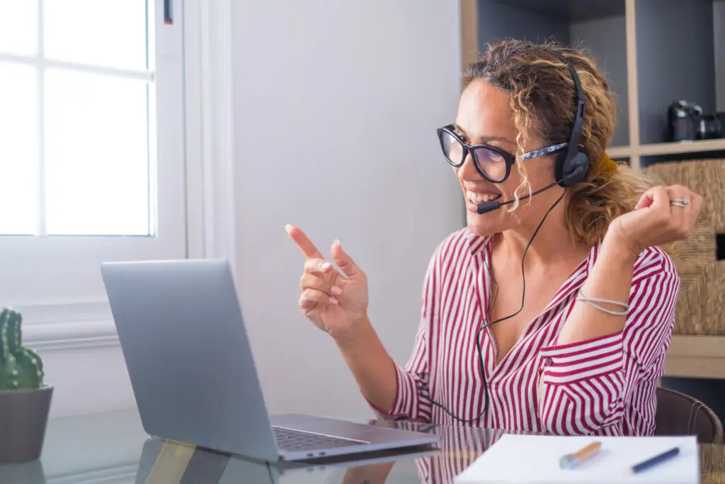 Attractive caucasian woman working as a virtual tour guide for Finland Private Tours, engaging with clients from her home office