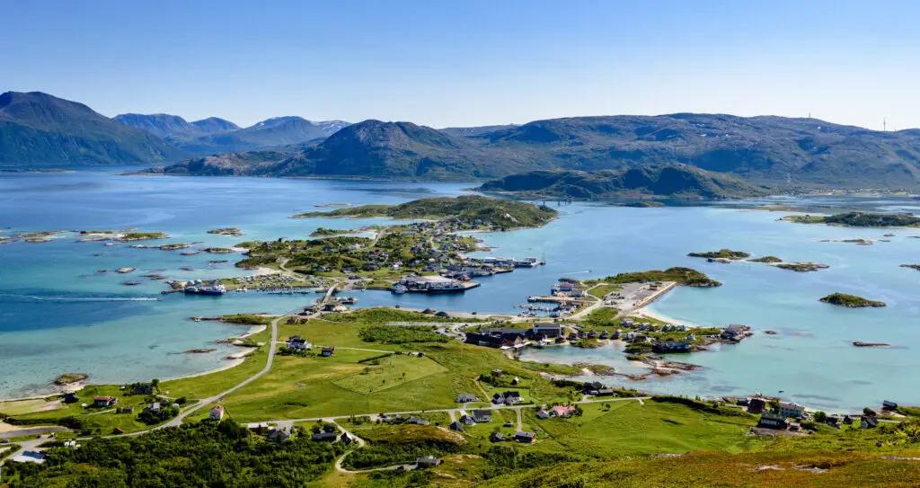 Aerial view of Sommarøy island in Northern Norway featuring turquoise waters, scattered islets, and lush green landscapes during summer.